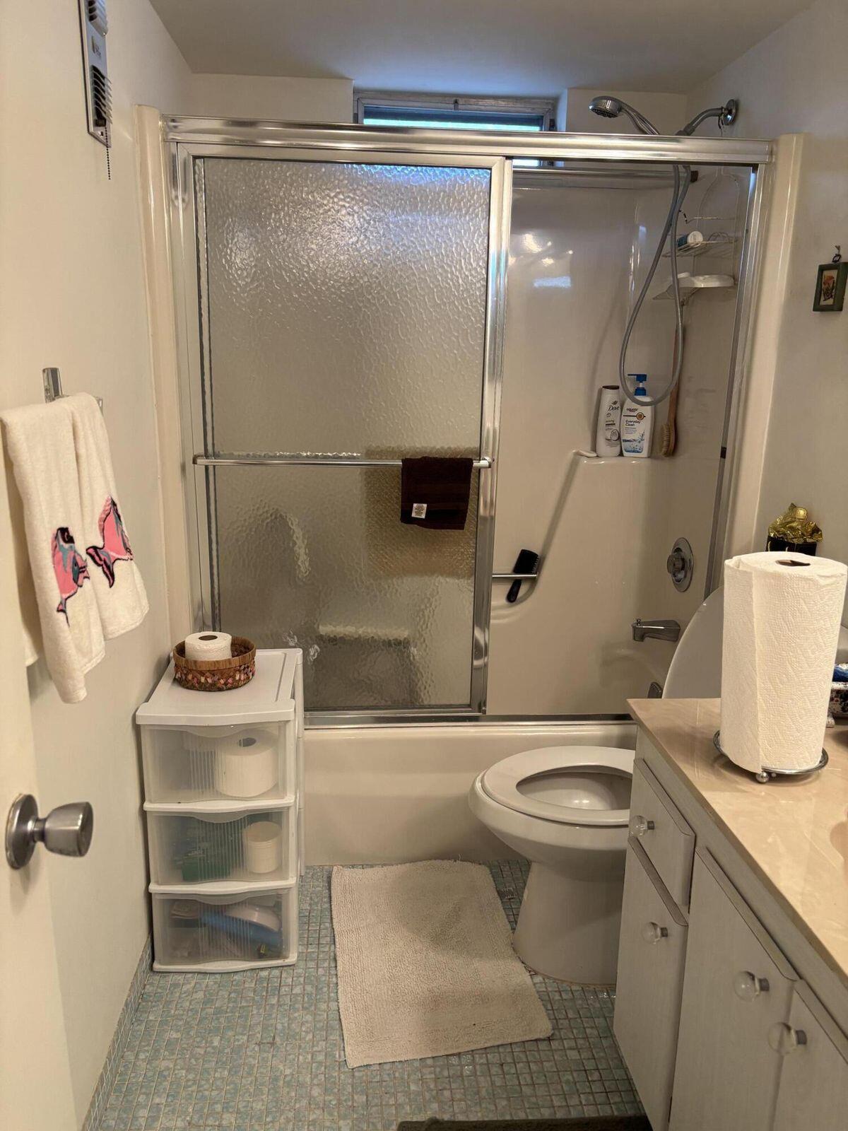 230 Northeast 26th Avenue, Unit 2140 Boynton Beach, FL 33435 - Photo 7 of 9 a bathroom with a sink toilet and shower