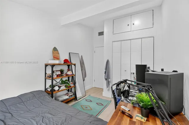 a bedroom with a bed and a large window