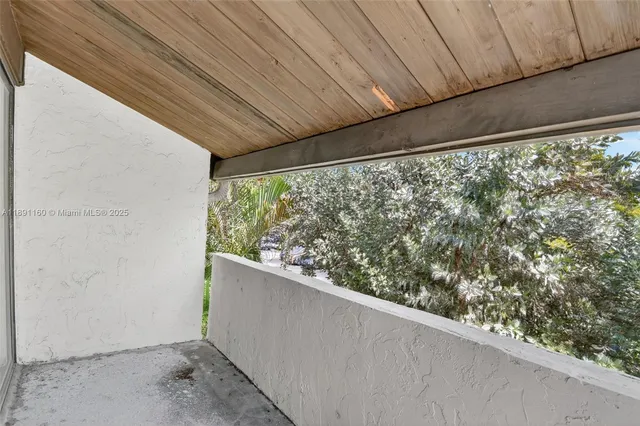 an aerial view of a city with lots of residential buildings ocean and mountain view in back
