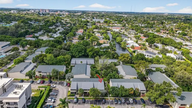 a view of a house with a yard and large tree