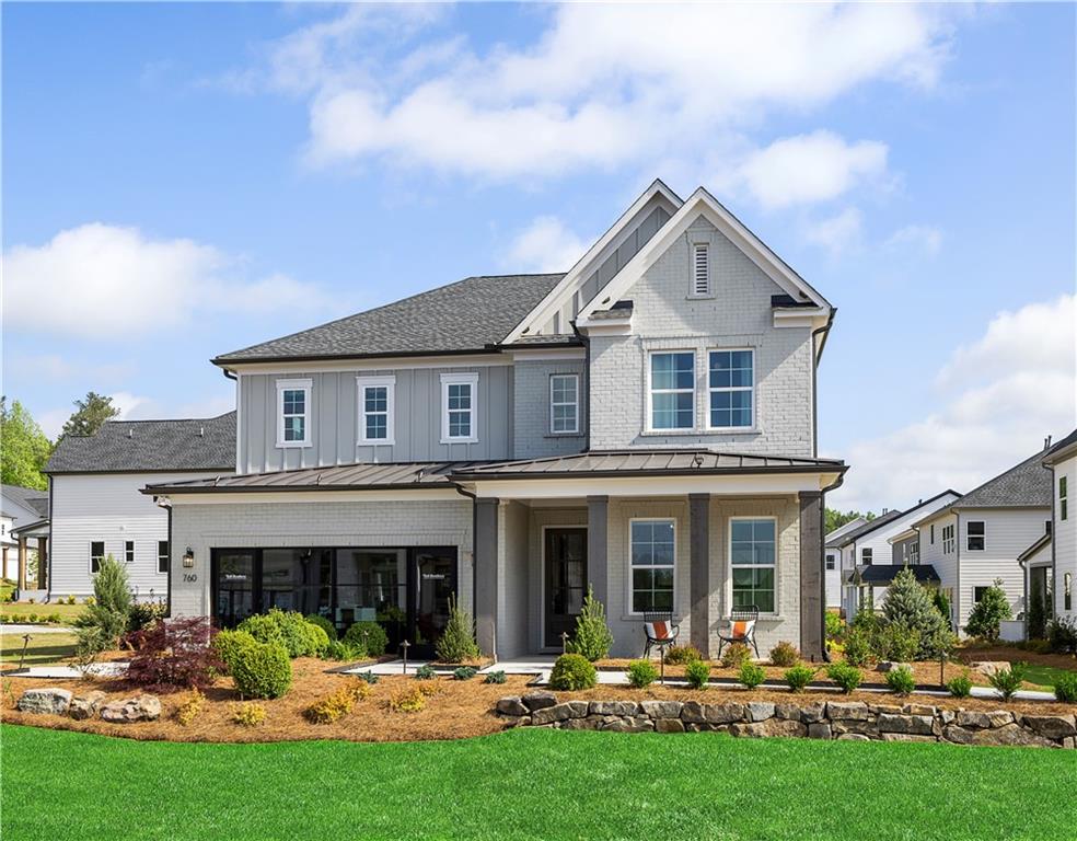 a front view of multiple houses with yard and green space