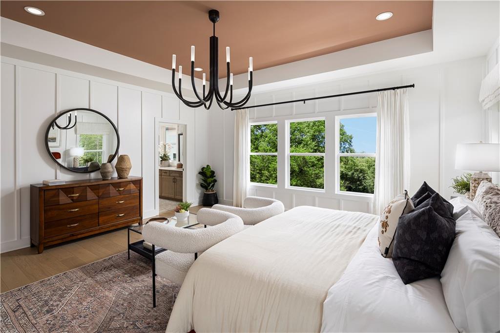 760 Keystone Drive Woodstock, GA 30188 - Photo 11 of 26 a bedroom with a bed a chandelier with the large mirror on the dresser and a chandelier