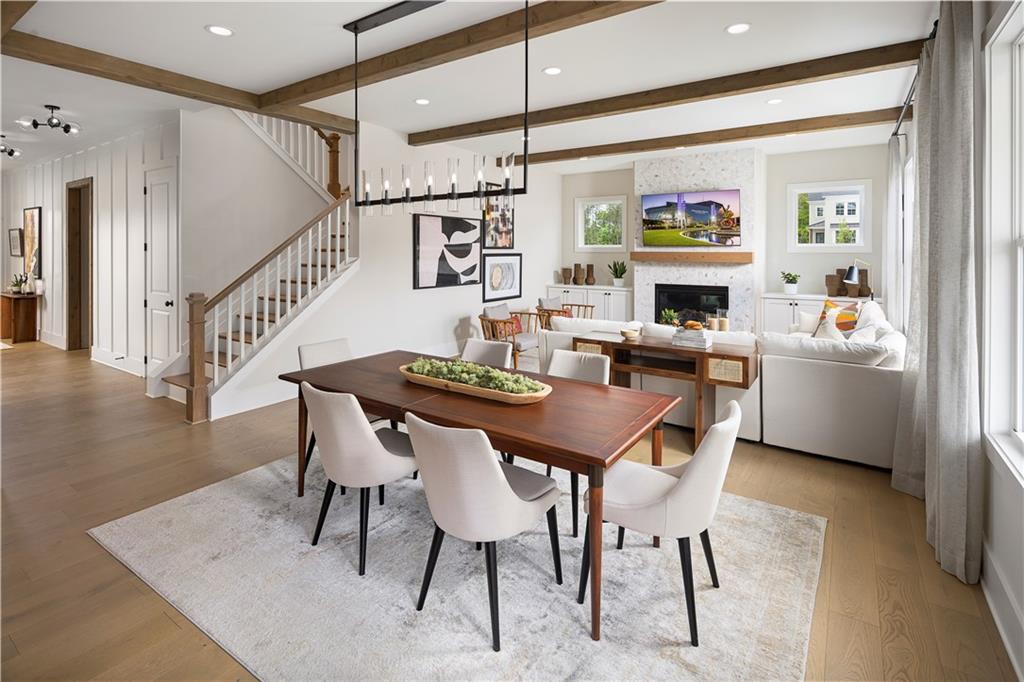 760 Keystone Drive Woodstock, GA 30188 - Photo 3 of 26 a dining room with furniture a rug and a painting