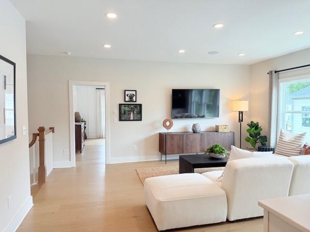 760 Keystone Drive Woodstock, GA 30188 - Photo 9 of 26 a living room with furniture a flat screen tv and a view of kitchen