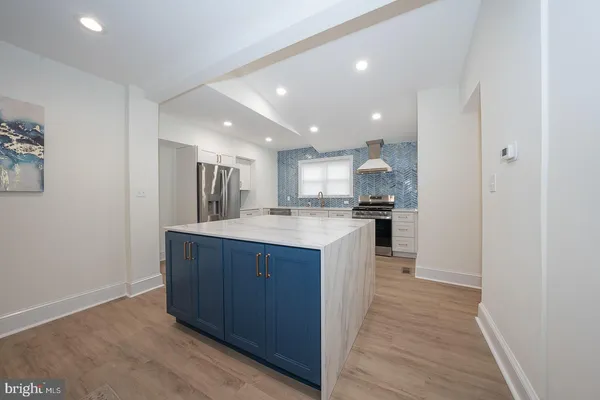 a kitchen with a refrigerator and a sink
