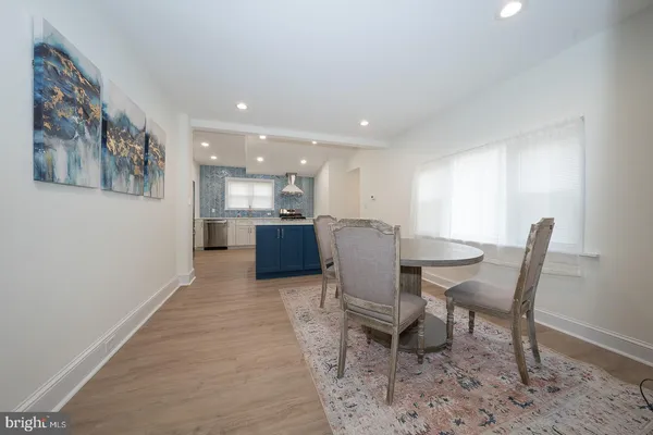 a kitchen with stainless steel appliances granite countertop a stove a sink and a white wooden cabinets