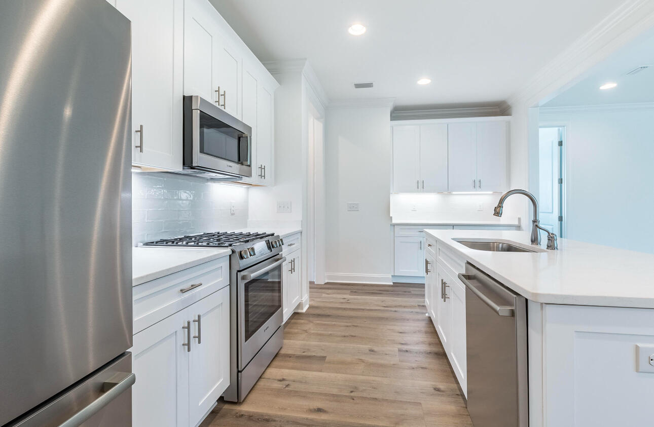 19 Conifer Ct Inlet Beach Inlet Beach, FL 32461 - Photo 3 of 5 a kitchen with stainless steel appliances granite countertop a sink and a stove top oven