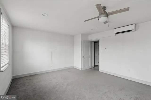 a view of a livingroom with a hardwood floor and a ceiling fan