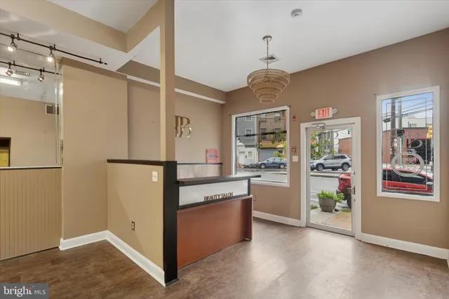 a view of kitchen with stainless steel appliances granite countertop cabinets and a window
