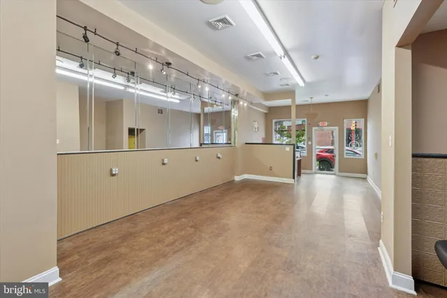 a view of a hallway with wooden cabinet