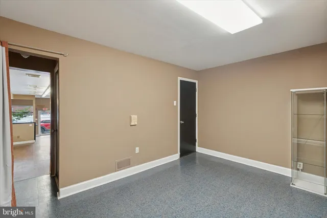 a kitchen with a refrigerator and cabinets