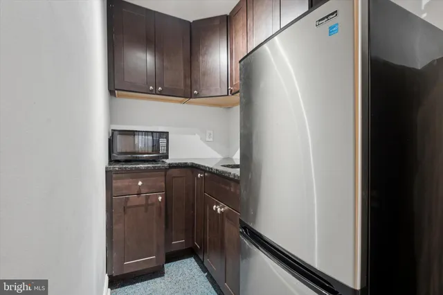 a bathroom with a toilet sink vanity and mirror