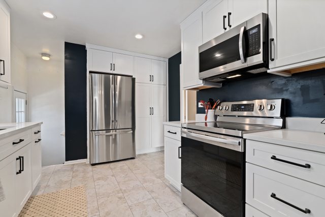 435 Sumac Road Highland Park, IL 60035 - Photo 10 of 30 a kitchen with stainless steel appliances white cabinets and a refrigerator