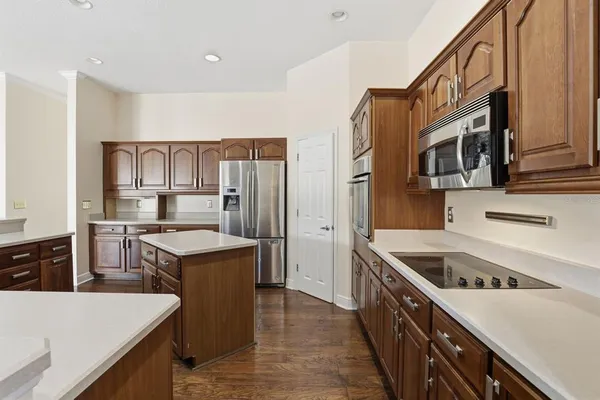 a kitchen with a stove a refrigerator and a sink