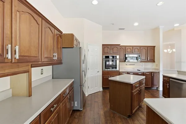 a kitchen with stainless steel appliances granite countertop a sink stove and refrigerator