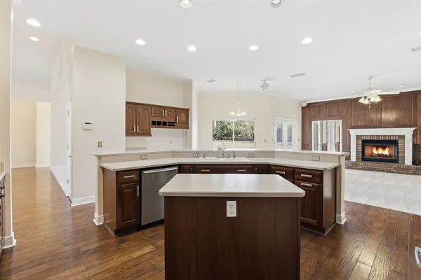a kitchen with a table chairs sink and cabinets