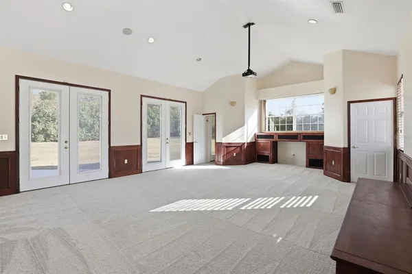 a large bedroom with a large bed and large window