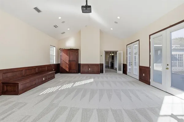 a large room with a bed and a large mirror