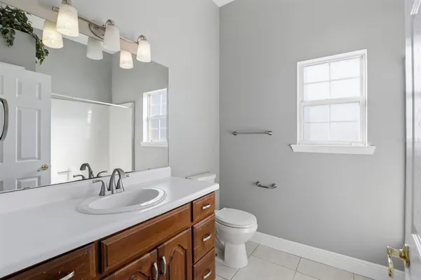 a bathroom with a sink a toilet and a mirror