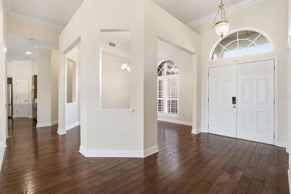 a view of a hallway with wooden floor