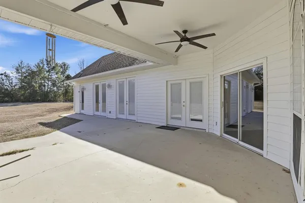 a view of a livingroom with a ceiling fan and entryway