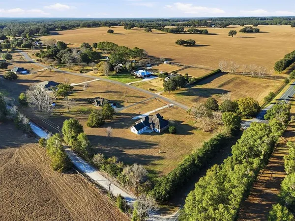 a view of a lake with lawn chairs