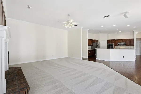 a view of a kitchen with a sink and a refrigerator