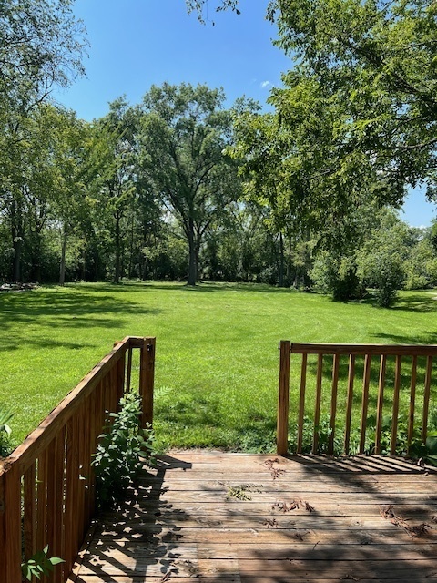 7740 South County Line Road Burr Ridge, IL 60527 - Photo 2 of 13 a view of a wooden deck with a yard