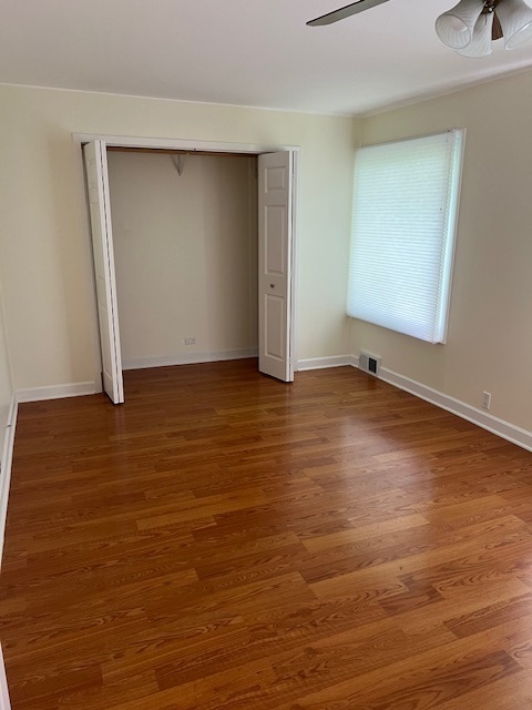 7740 South County Line Road Burr Ridge, IL 60527 - Photo 10 of 13 an empty room with wooden floor and closet