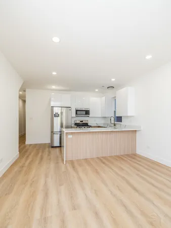 a kitchen with stainless steel appliances a refrigerator and a stove top oven