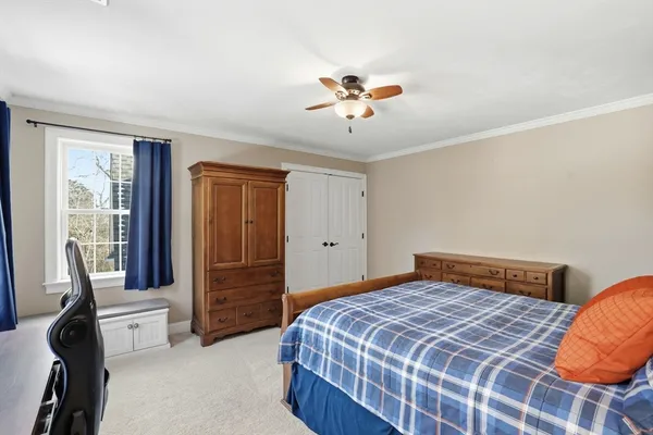 a bedroom with a bed and a chandelier