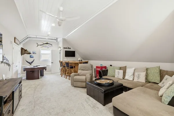 a living room with furniture and flat screen tv