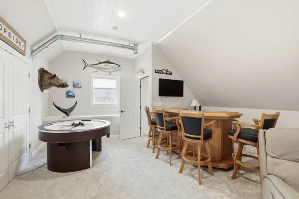 a room with a table chairs and a wooden floor