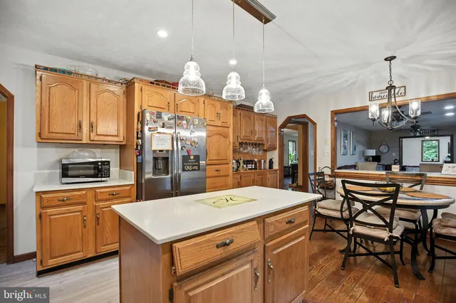 a view of a dining room with furniture wooden floor and chandelier
