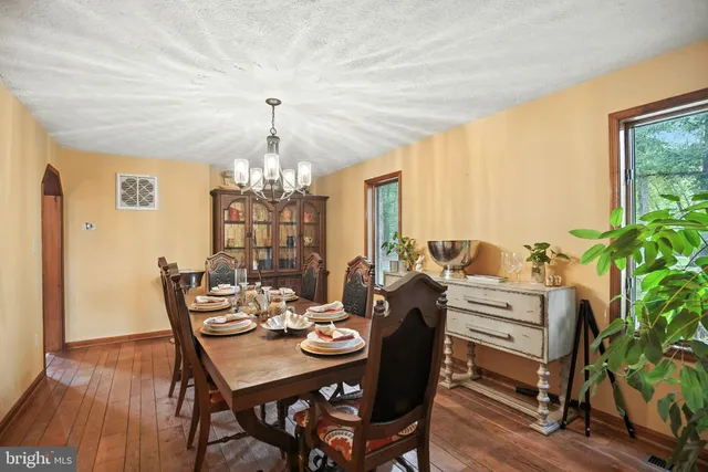 a very nice looking dining room with a large window and chairs