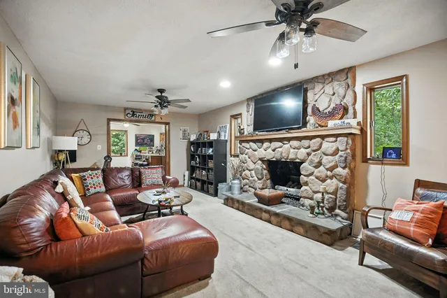 a view of a hallway with wooden floor and windows