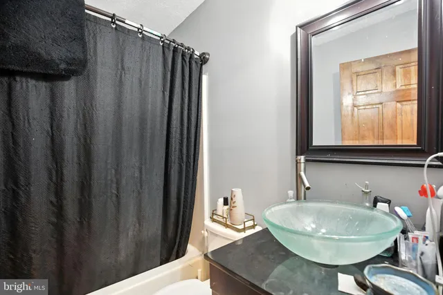 a view of a patio with table and chairs under an umbrella with wooden floor