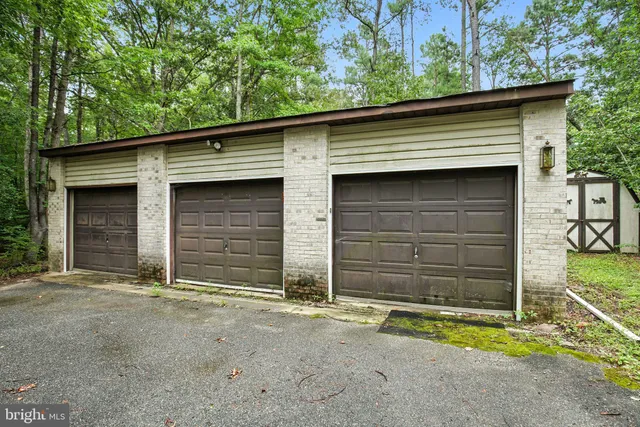 a sign that is sitting in front of flowers