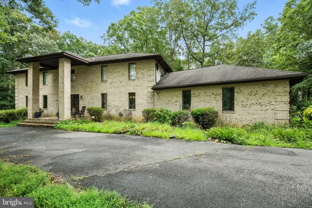 a view of a house with a yard and sitting area