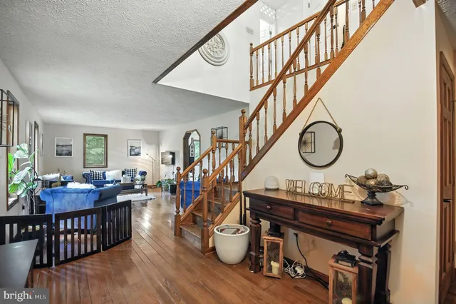 a kitchen with stainless steel appliances a dining table chairs and wooden floor