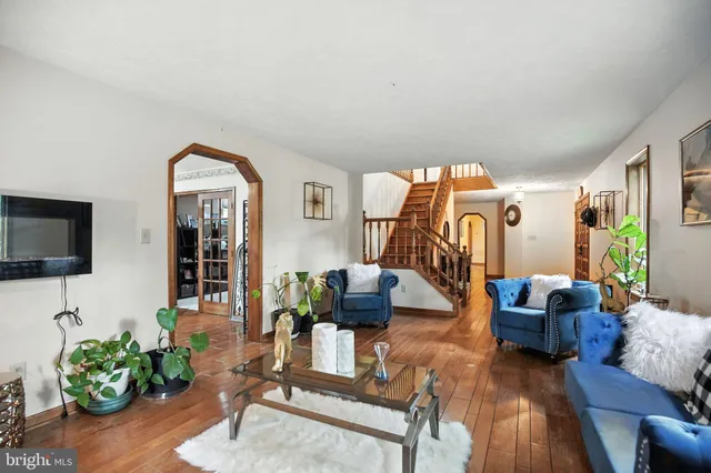 a dining room with furniture a chandelier and wooden floor