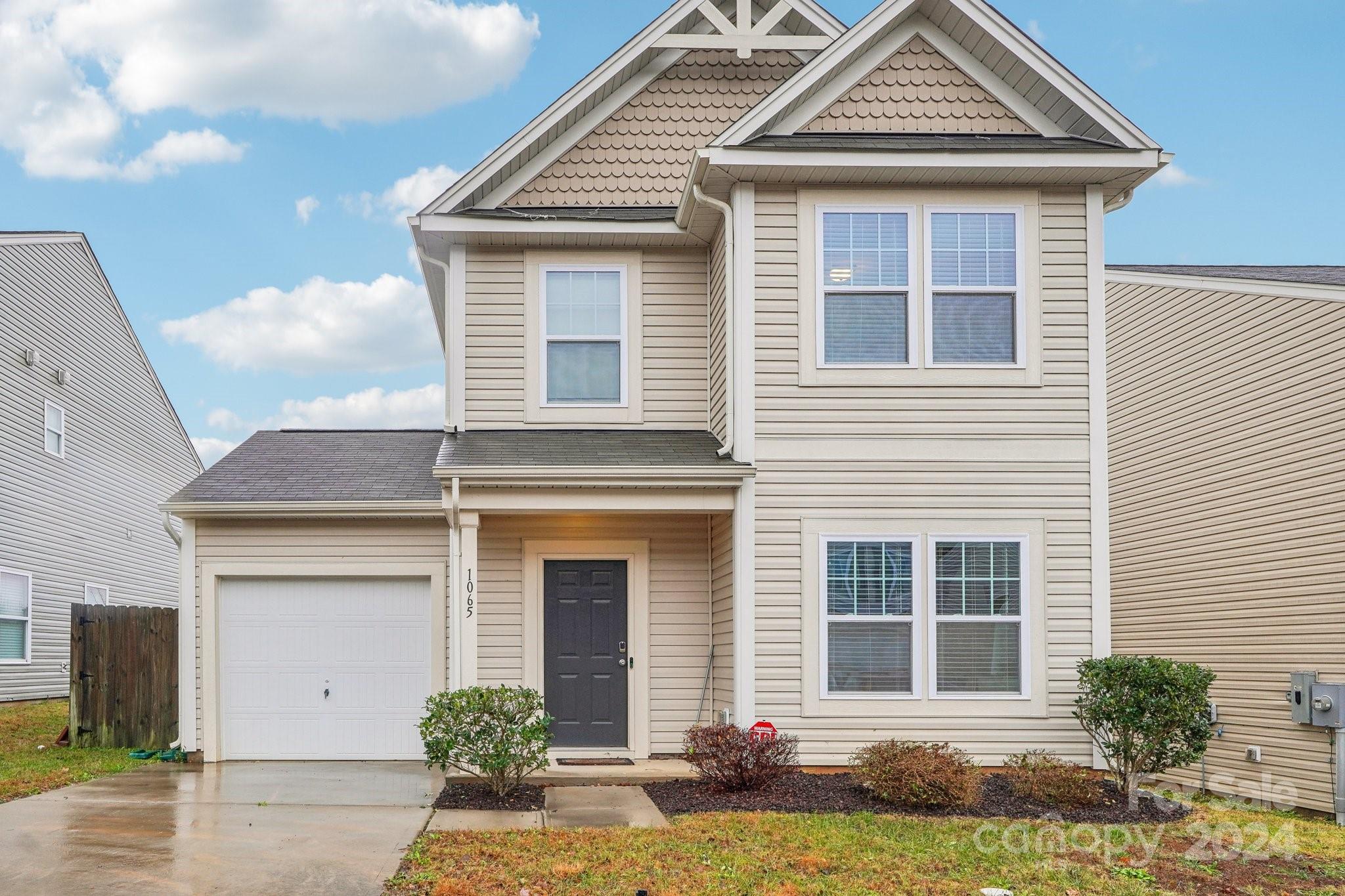 a front view of a house with garden
