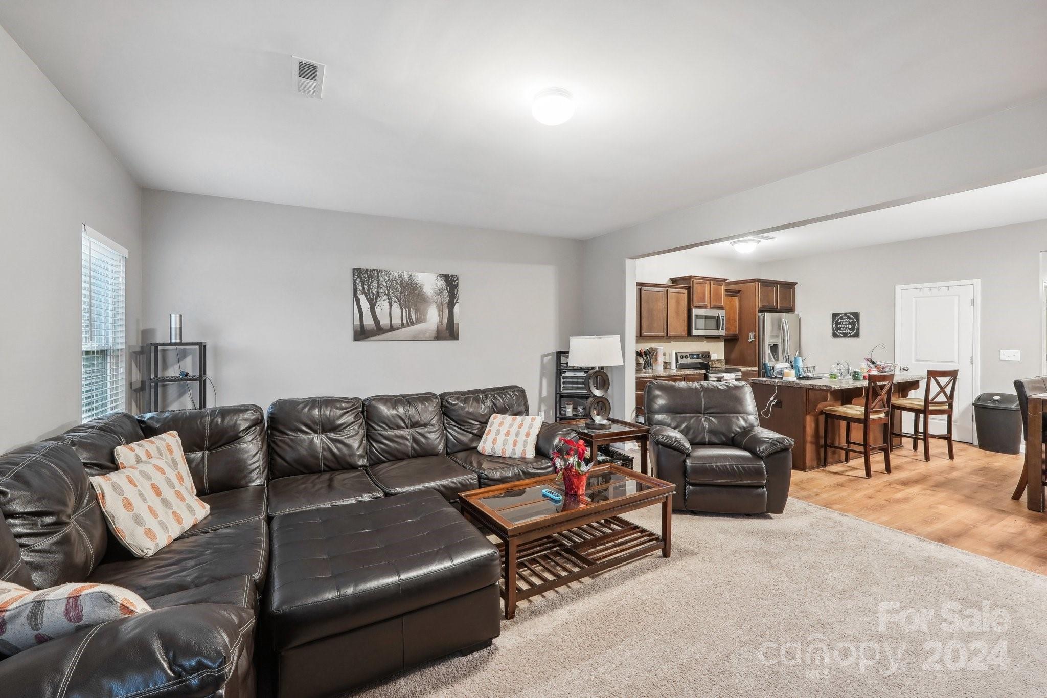 1065 Ramsgate Drive Southwest Concord, NC 28025 - Photo 11 of 47 a living room with furniture or couch and a dining table