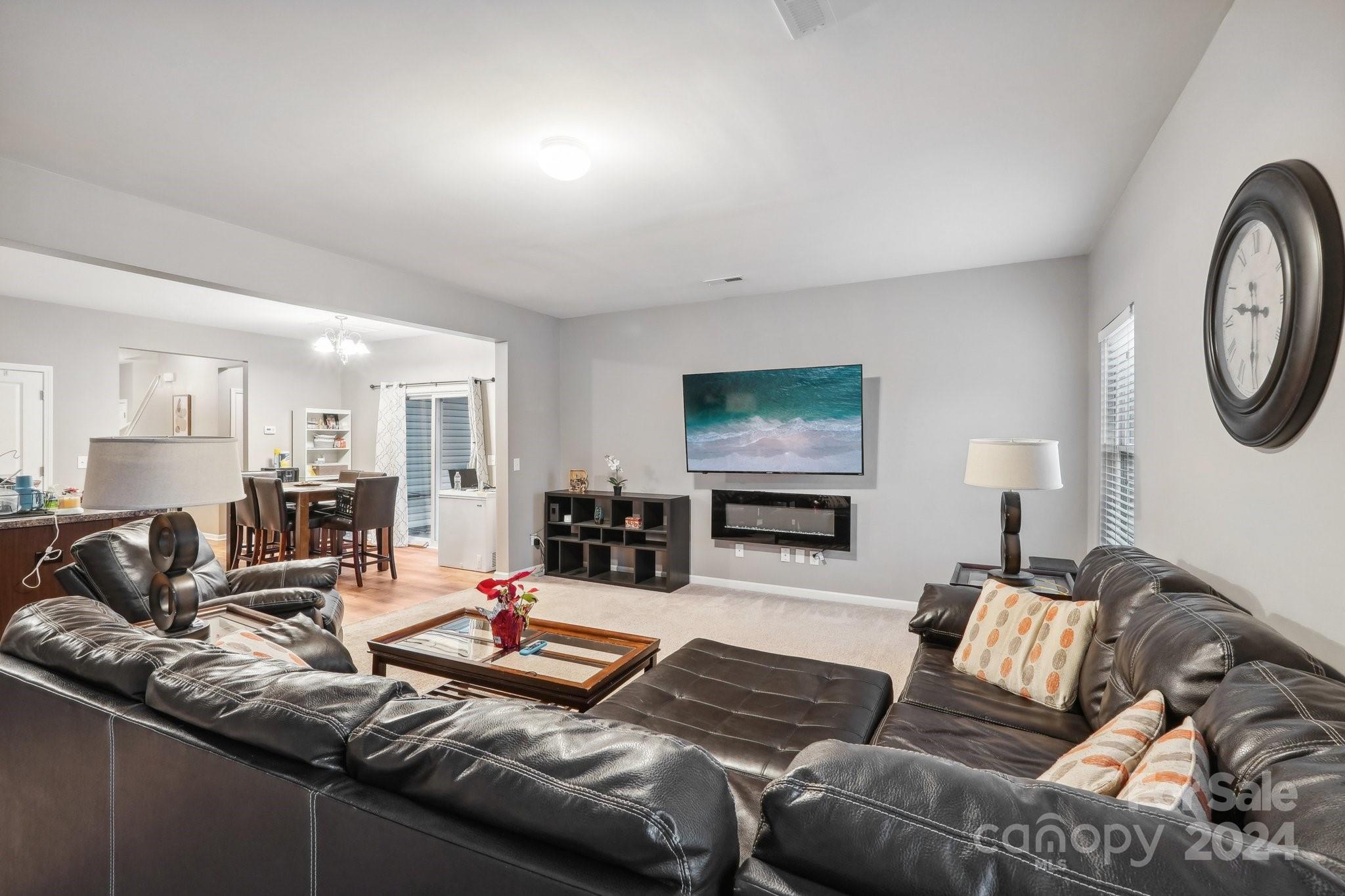 1065 Ramsgate Drive Southwest Concord, NC 28025 - Photo 12 of 47 a living room with furniture and a flat screen tv