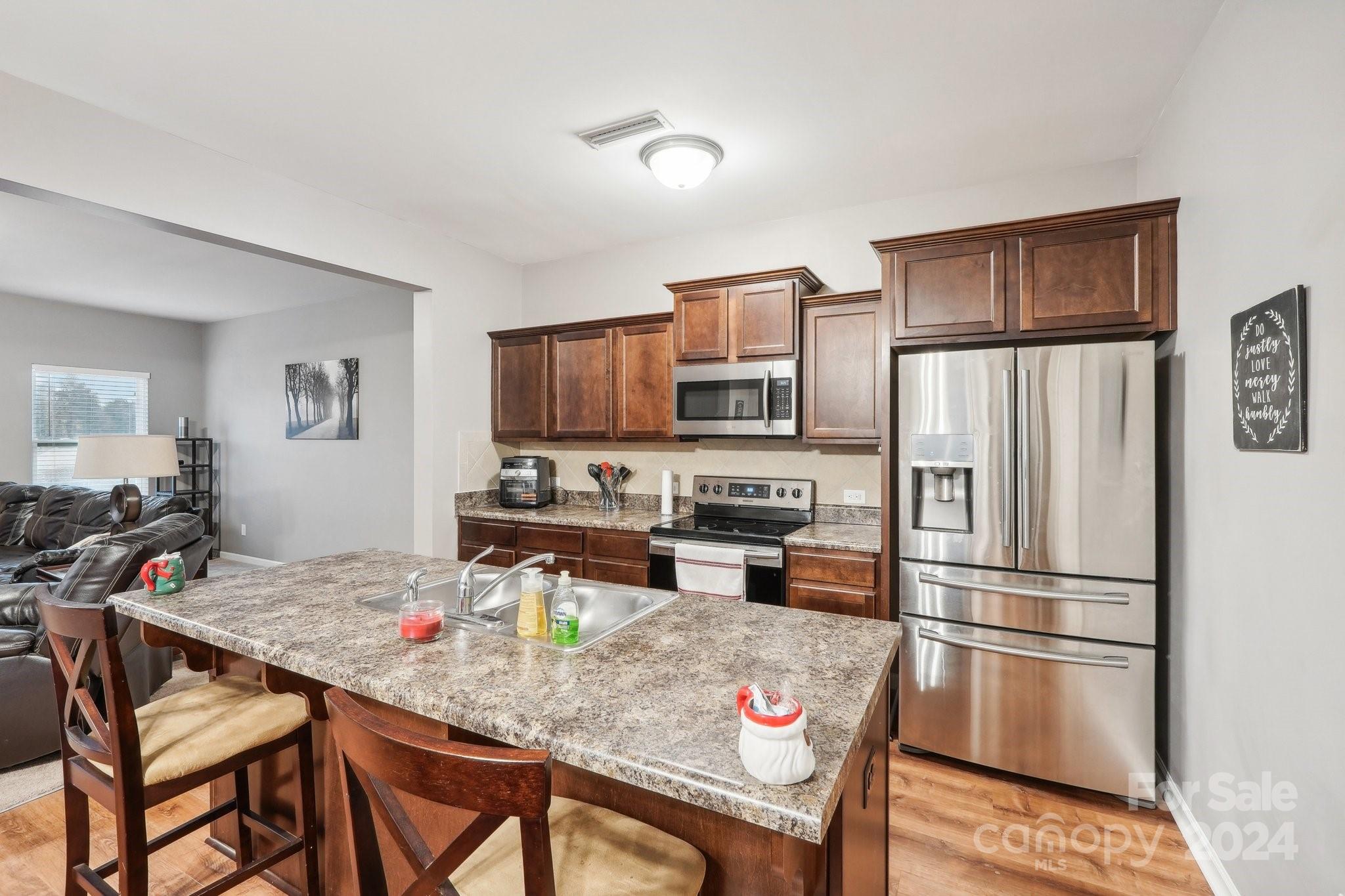 1065 Ramsgate Drive Southwest Concord, NC 28025 - Photo 16 of 47 a kitchen with stainless steel appliances granite countertop a refrigerator stove microwave and sink