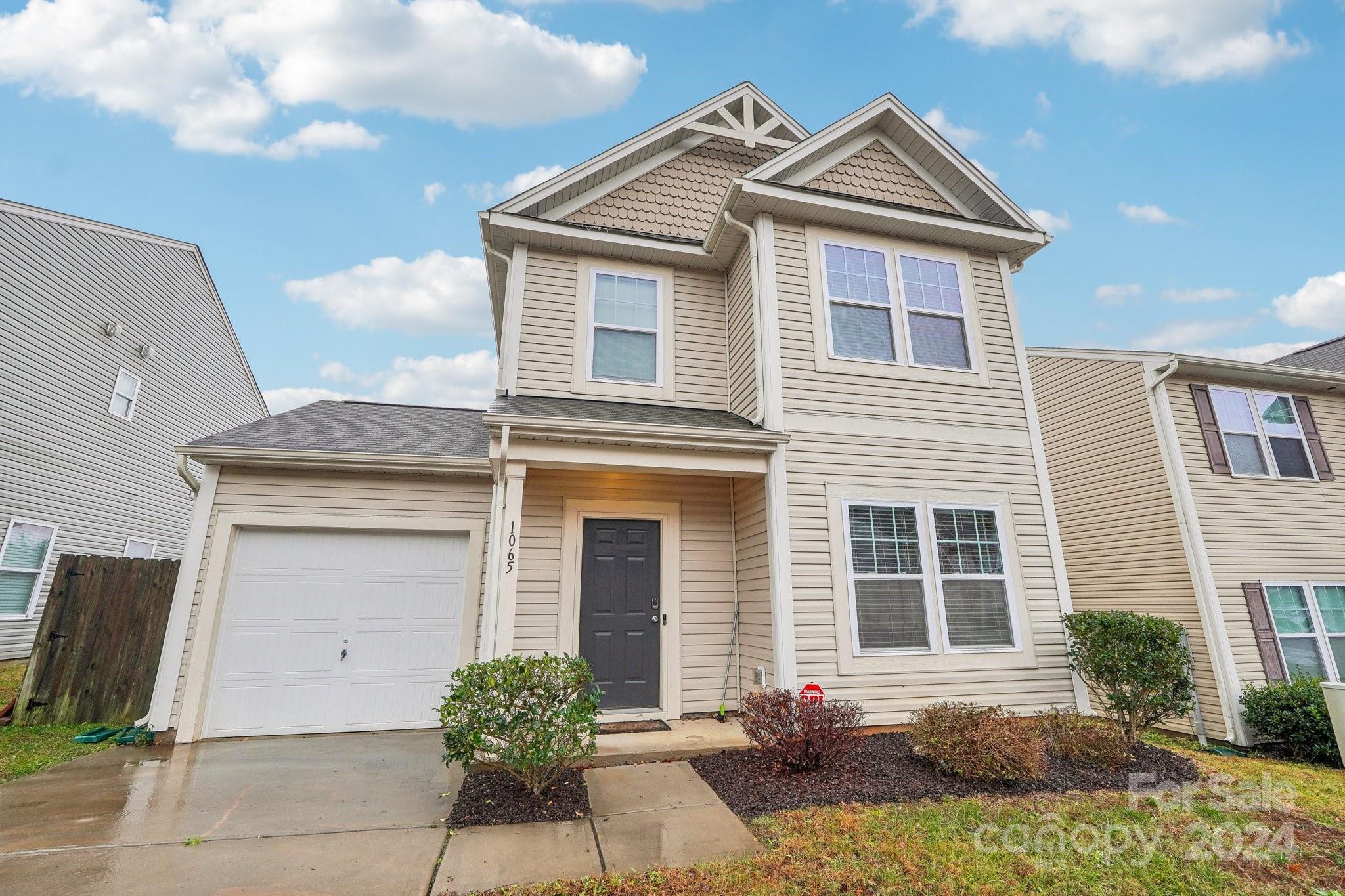 1065 Ramsgate Drive Southwest Concord, NC 28025 - Photo 2 of 47 a front view of a house with a yard and garage