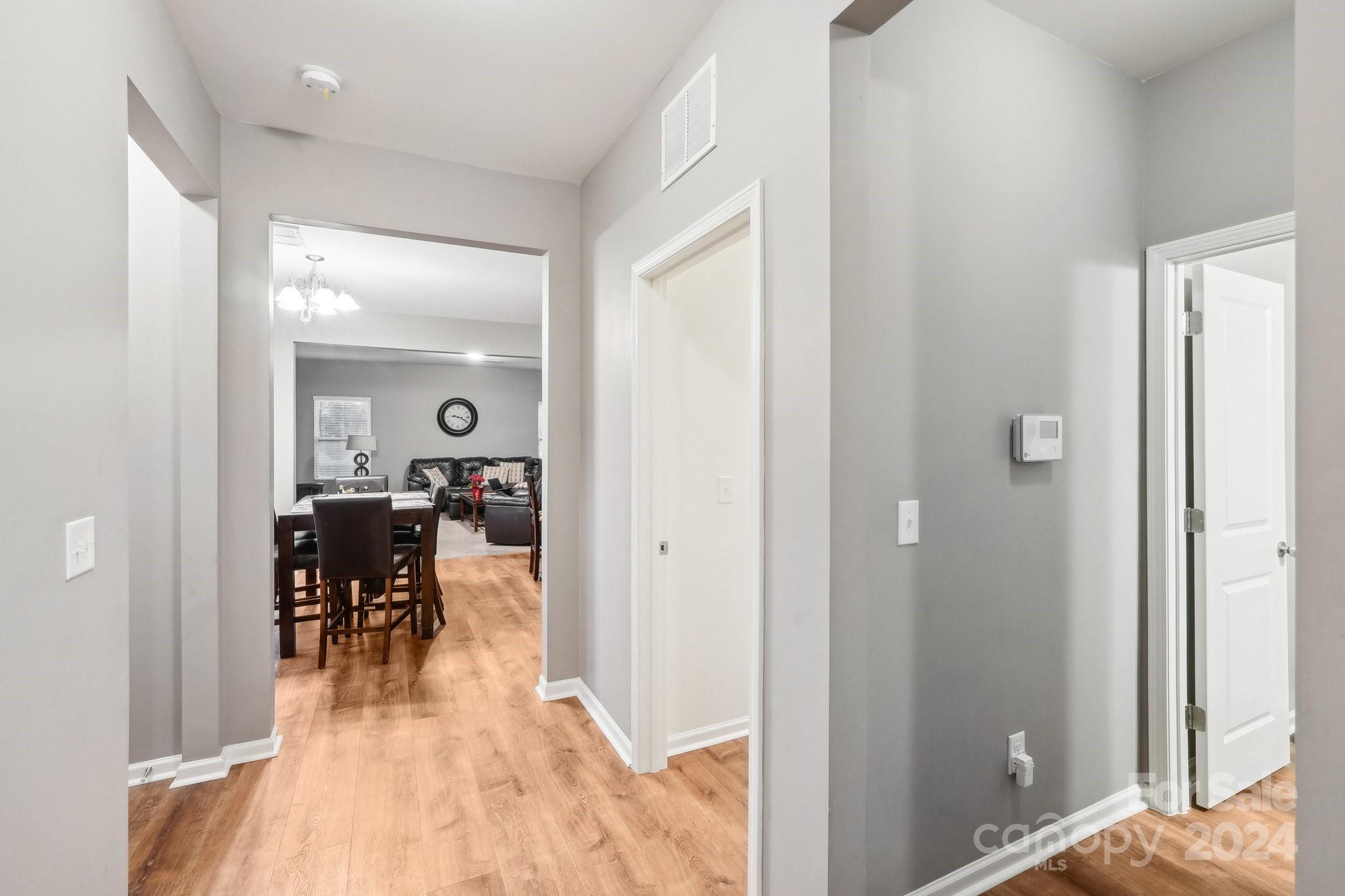 1065 Ramsgate Drive Southwest Concord, NC 28025 - Photo 22 of 47 a view of a dining room and livingroom with furniture wooden floor a chandelier