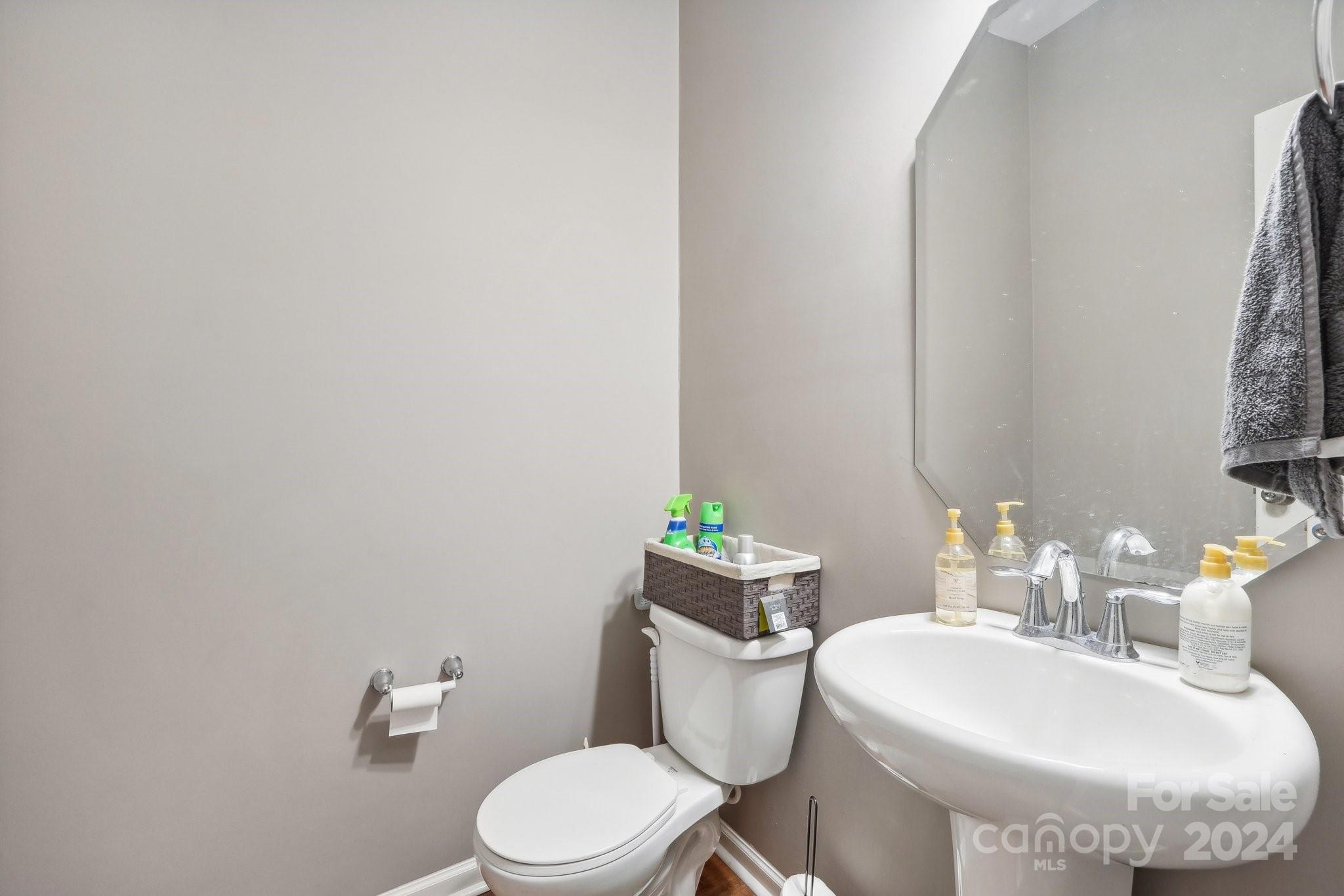 1065 Ramsgate Drive Southwest Concord, NC 28025 - Photo 24 of 47 a white toilet sitting next to a bathroom sink