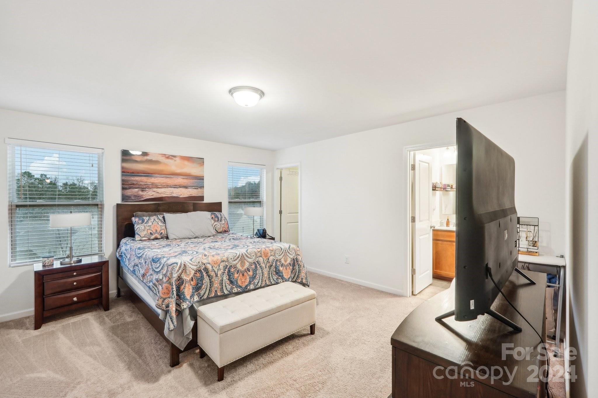 1065 Ramsgate Drive Southwest Concord, NC 28025 - Photo 29 of 47 a bedroom with a bed and large windows
