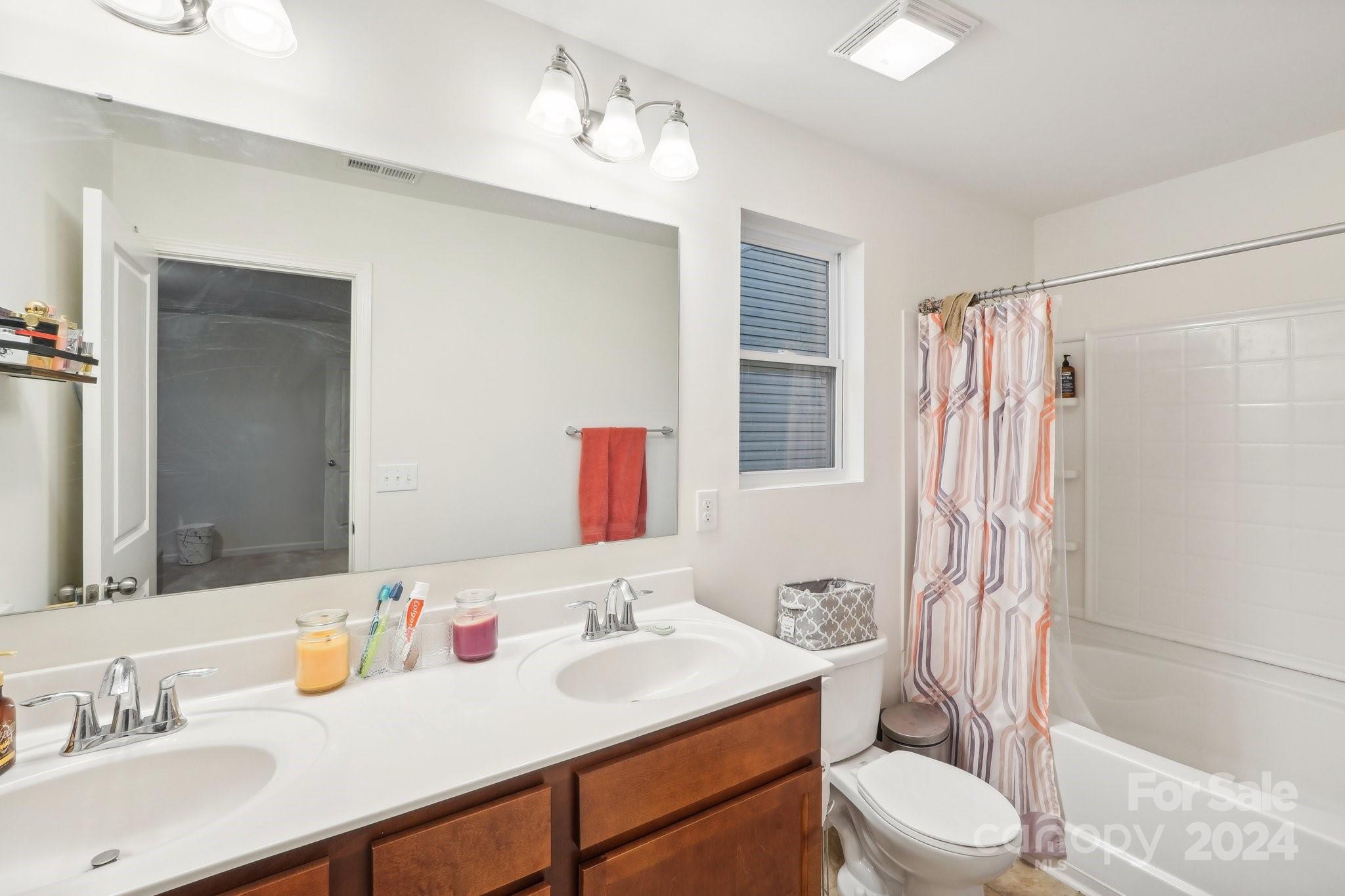 1065 Ramsgate Drive Southwest Concord, NC 28025 - Photo 34 of 47 a bathroom with a sink toilet vanity tub and shower